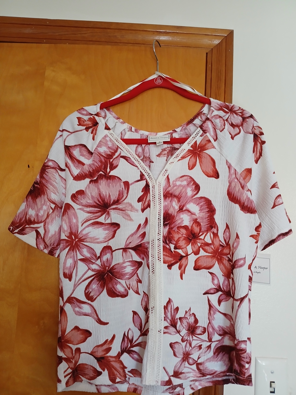 A. Newper White Top with Red Floral Print and V-Neck Trim